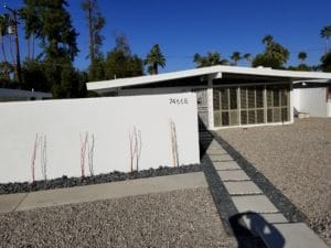 white stone wall in front of house
