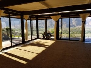 large sun room with painted decorative ceiling
